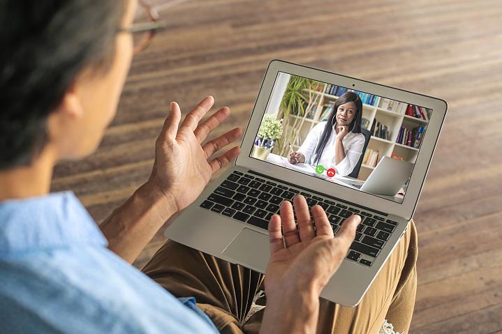 Foto de un hombre hablando con su proveedor de servicios de salud mental a través de una videoconferencia