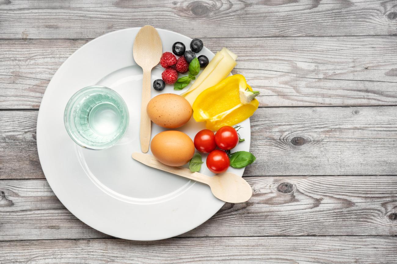 Imagen de un plato con cucharas a modo de manecillas de reloj, y que contiene comida entre las horas doce y  cuatro.