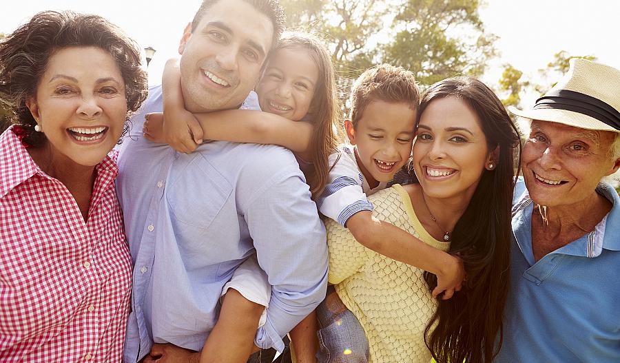 Retrato de una familia multigeneracional sonriendo juntos en un parque